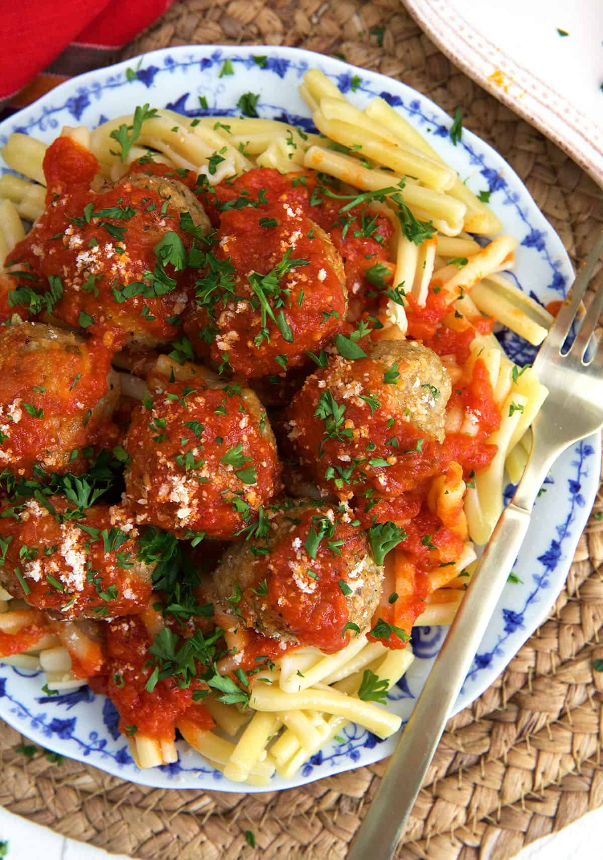 Pasta is served with red sauce and meatballs. 