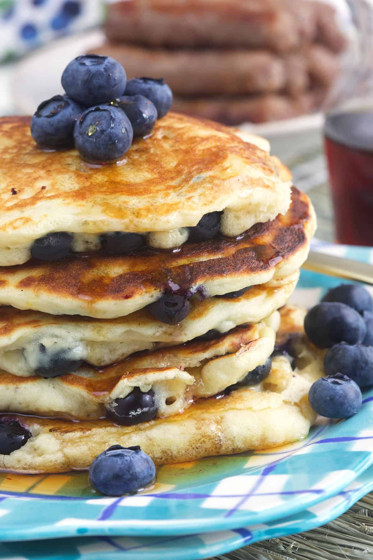 Fresh blueberries garnish a stack of pancakes. 