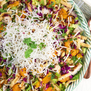 A large bowl is filled to the top with chinese chicken salad.
