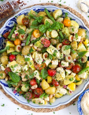 A large bowl is filled with Italian potato salad.