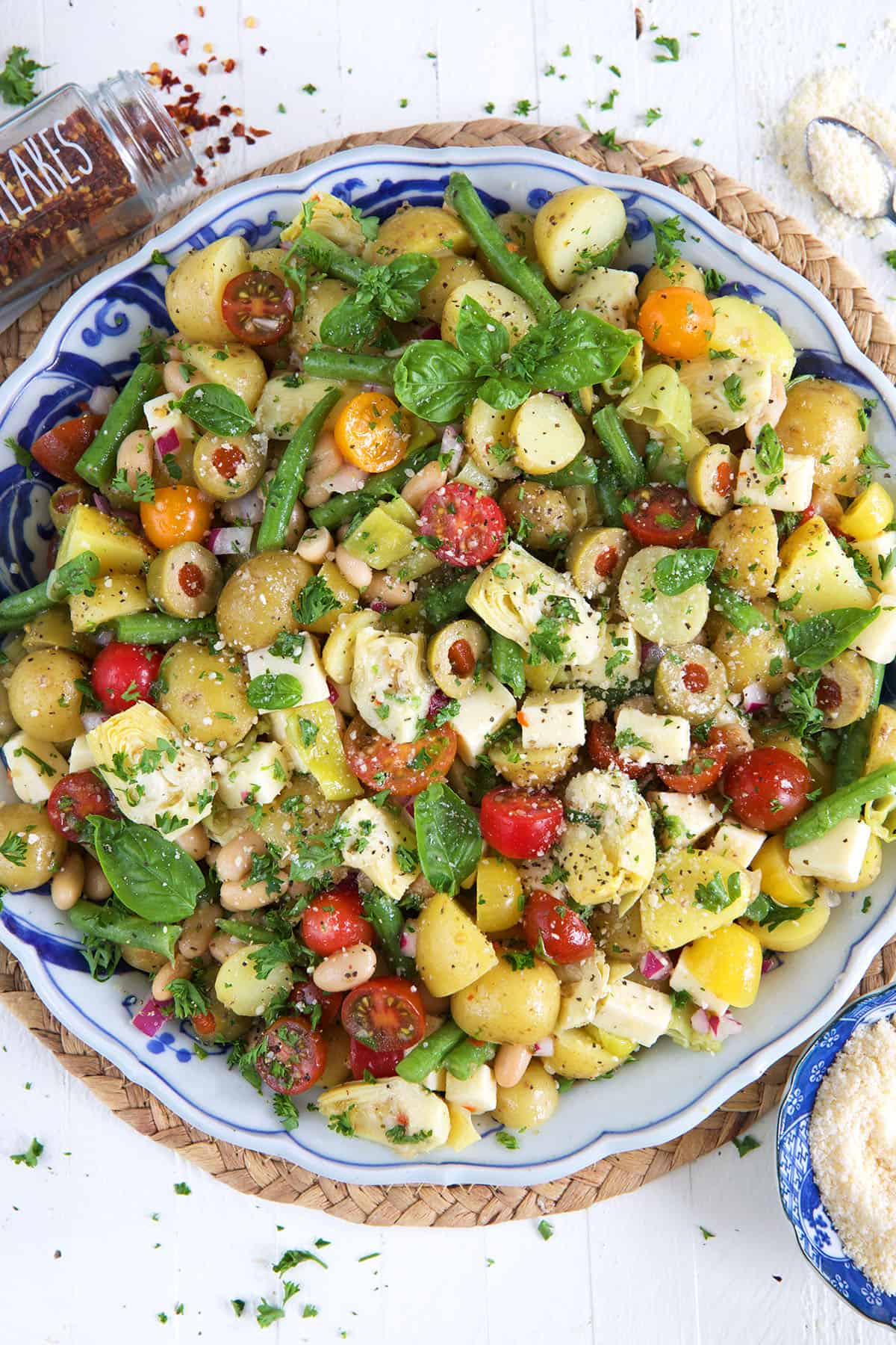 A large bowl is filled with Italian potato salad. 