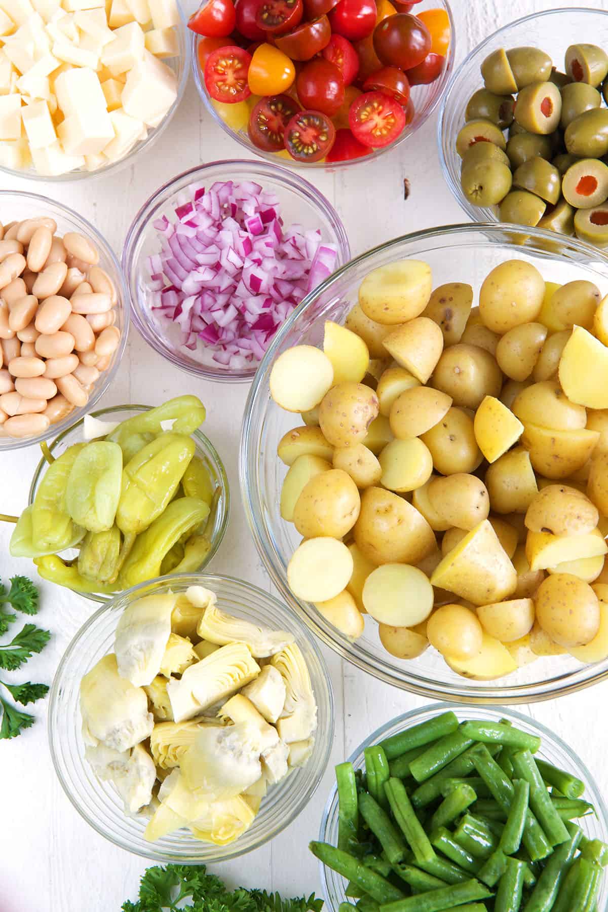 The ingredients for Italian potato salad are placed on a countertop. 