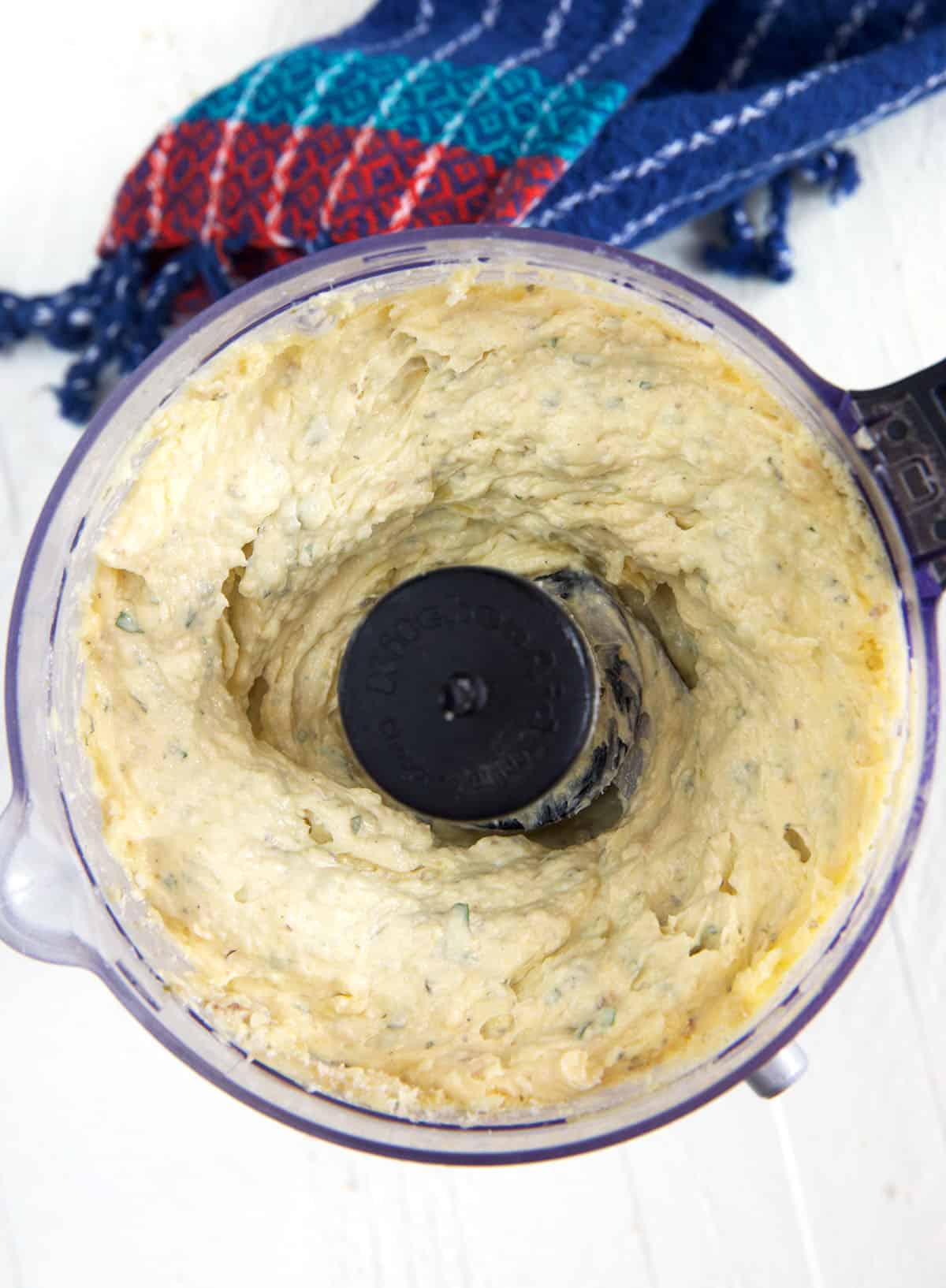 Garlic bread spread has been blended in a food processor. 