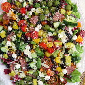 A large serving platter is filled with chopped salad.