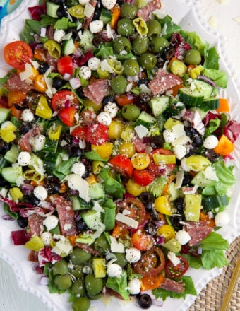 A large serving platter is filled with chopped salad.