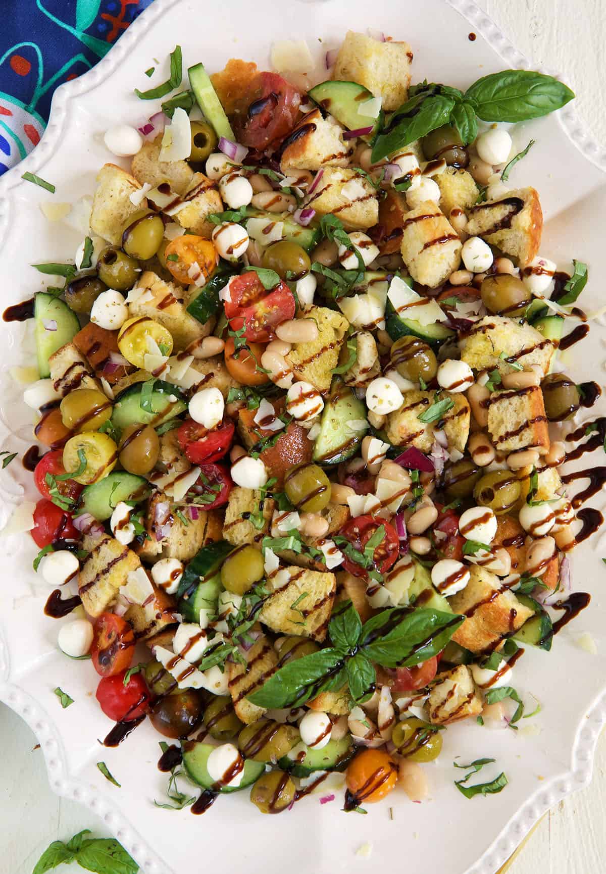 Balsamic reduction is drizzled all over panzanella salad. 