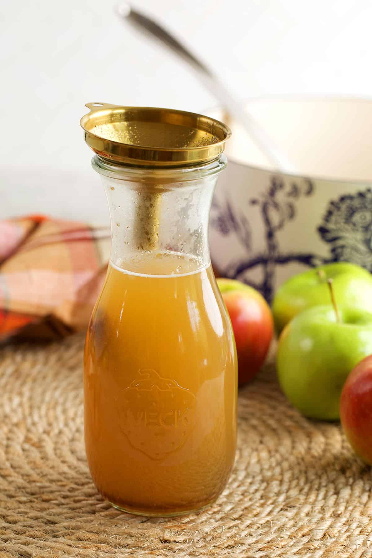 Funnel inside bottle of homemade apple cider