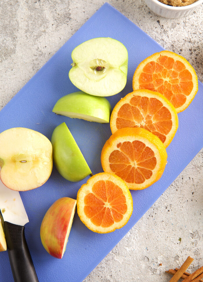 Sliced oranges and apples for apple cider