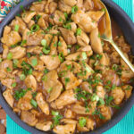A skillet is filled with cooked bourbon chicken.