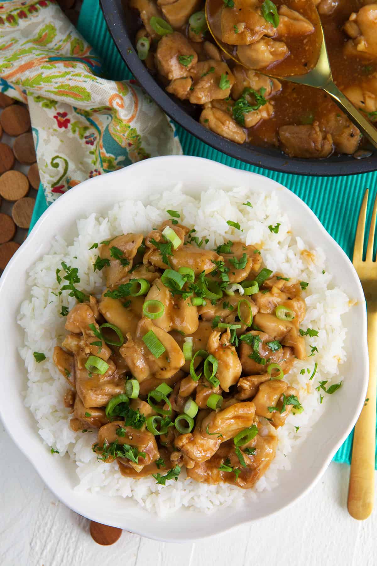 A serving of bourbon chicken is presented on a pile of white rice. 