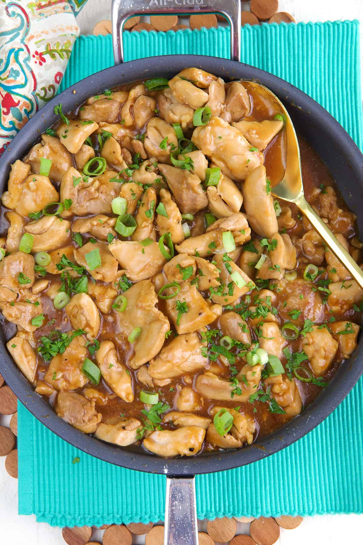 A skillet is filled with cooked bourbon chicken. 