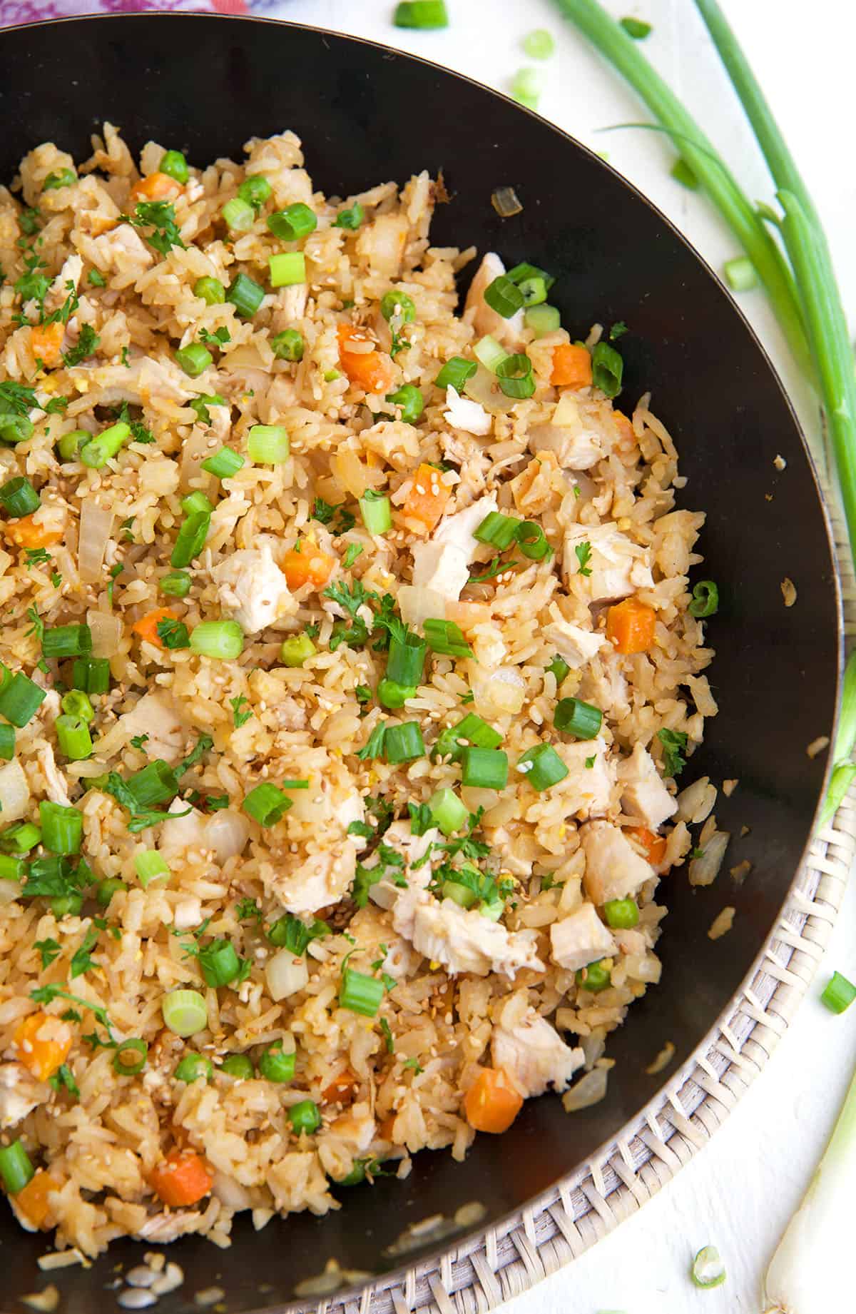 Half of a skillet is shown in the photo. It is filled with chicken fried rice. 