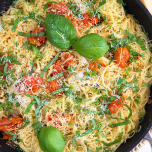 A skillet is filled with lemon garlic angel hair pasta.
