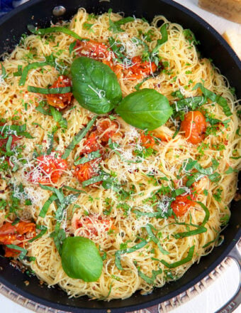 A skillet is filled with lemon garlic angel hair pasta.