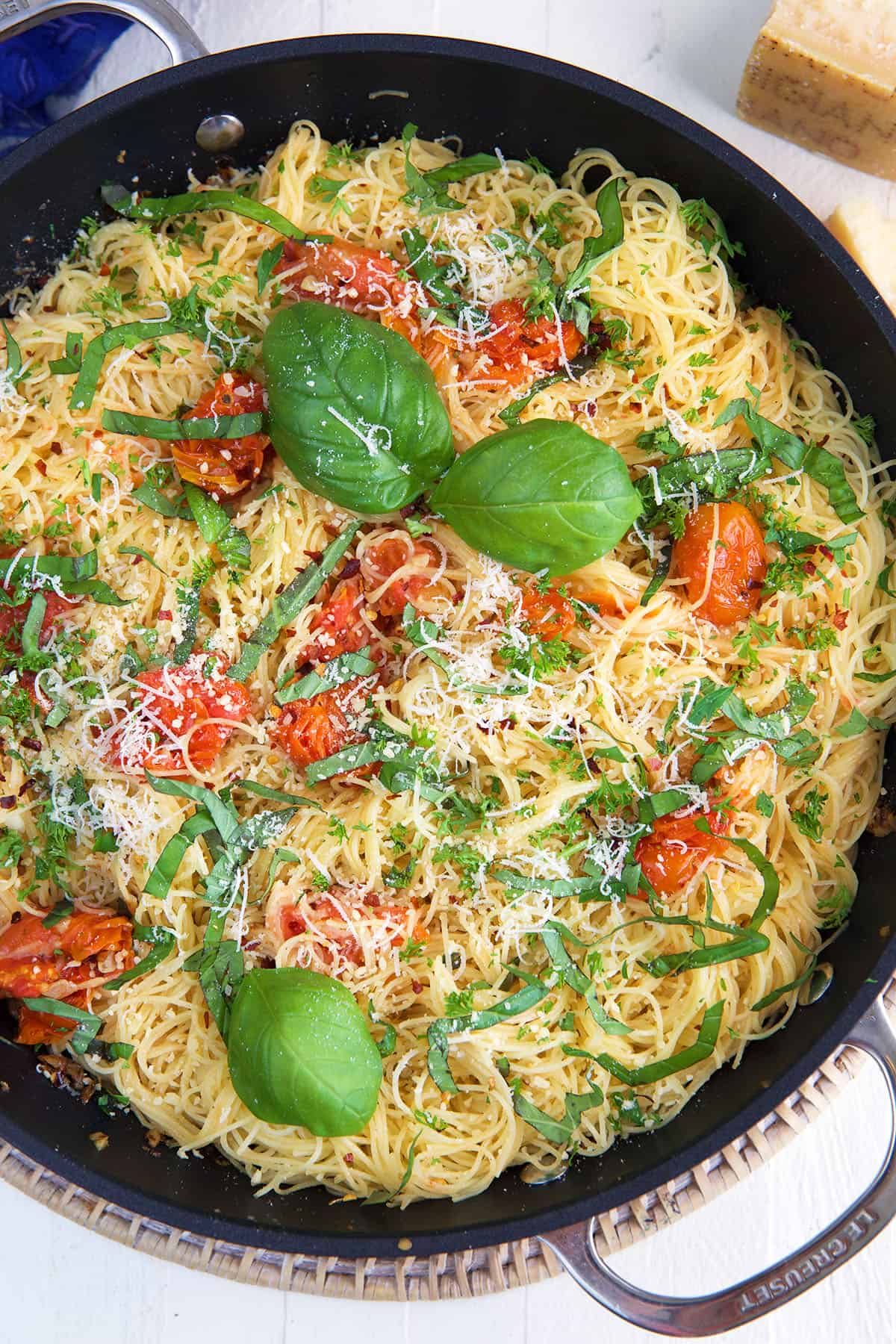 A skillet is filled with lemon garlic angel hair pasta. 