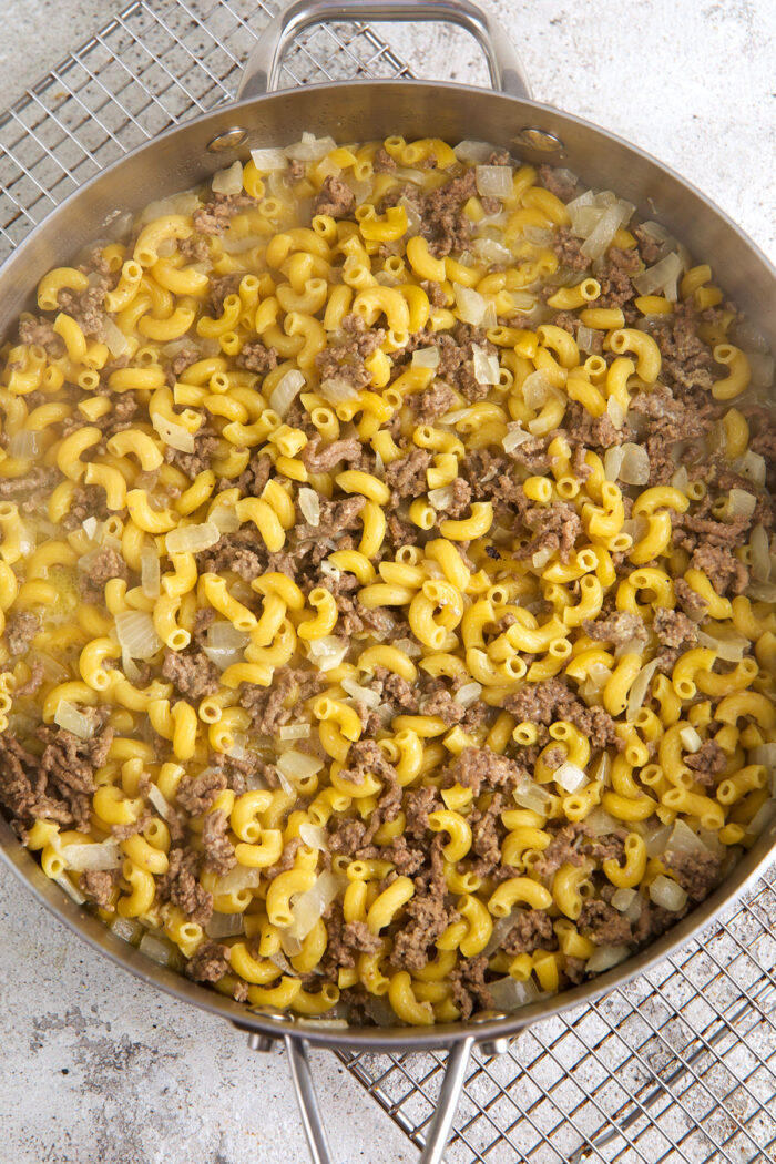 Homemade hamburger helper cheeseburger macaroni cooking in skillet