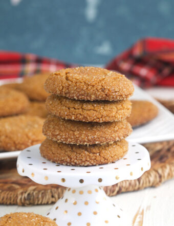 A stack of cookies is presented on a white serving tray.