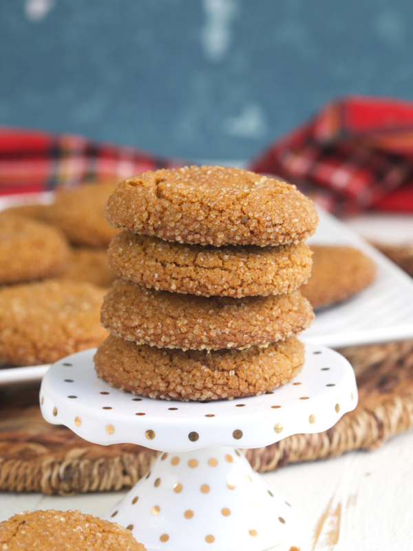A stack of cookies is presented on a white serving tray.