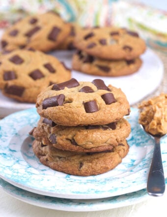 Cookies are stacked in a small pile on a round plate.