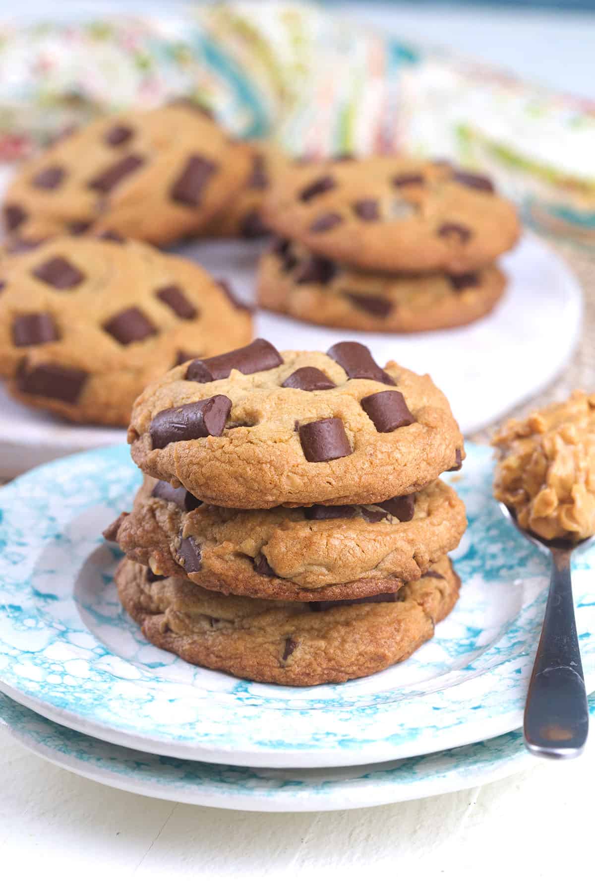 Cookies are stacked in a small pile on a round plate. 
