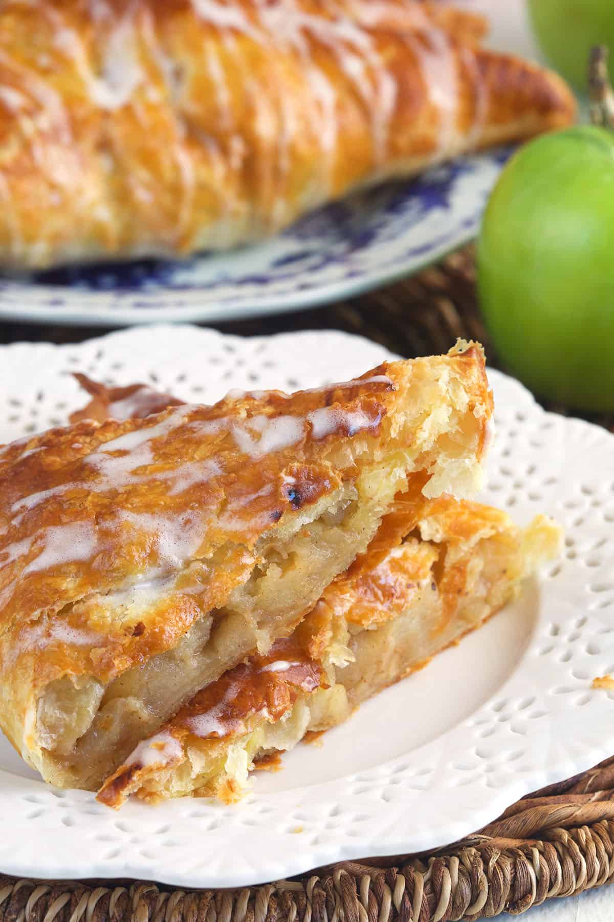 A halved apple turnover is placed on a white plate.