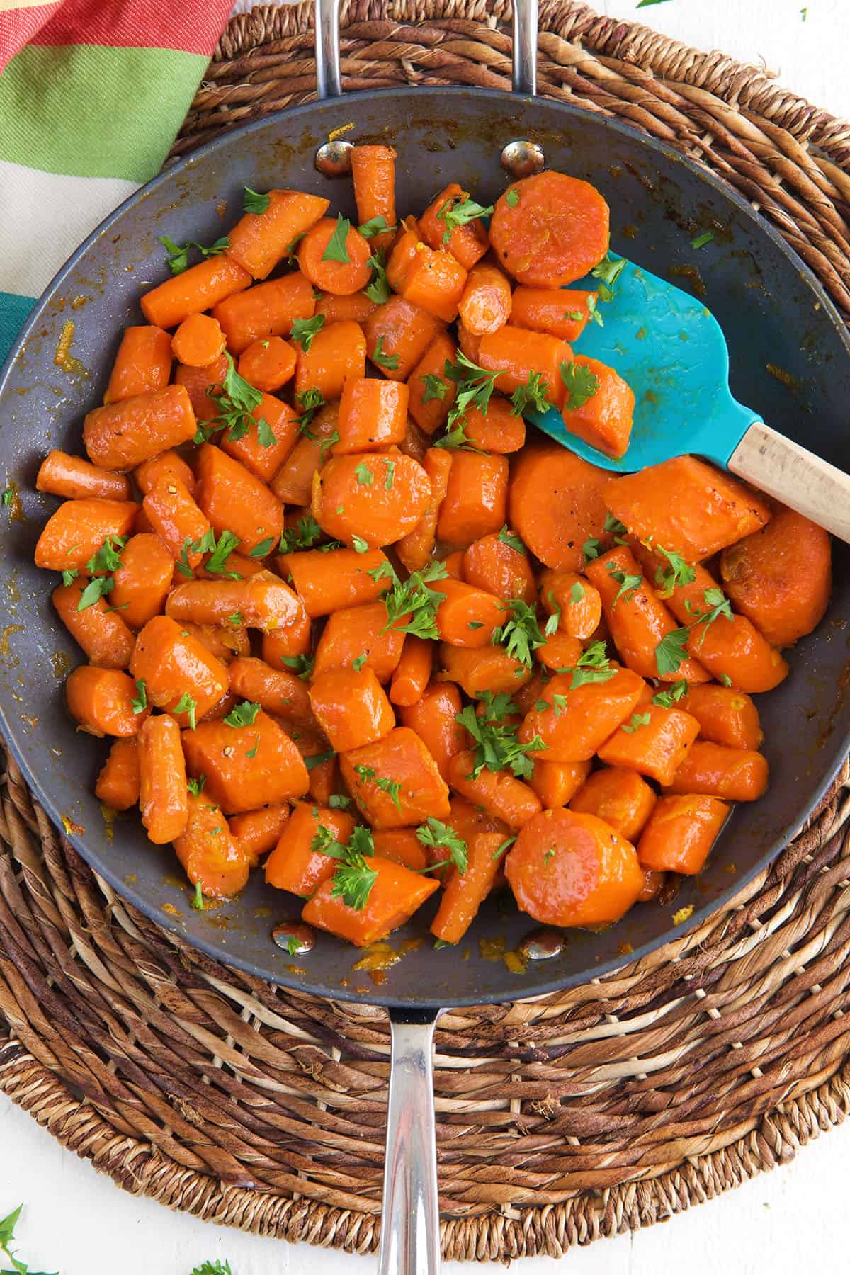 A skillet is filled with cooked carrots.