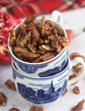 Stacked teacups are filled with candied pecans.