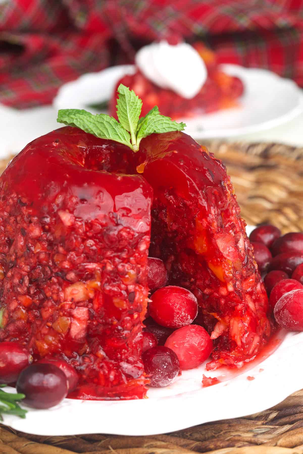 Real cranberries are placed all around a jello salad.