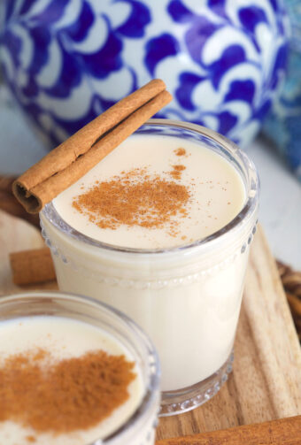 a glass of horchata is garnished with a cinnamon stick
