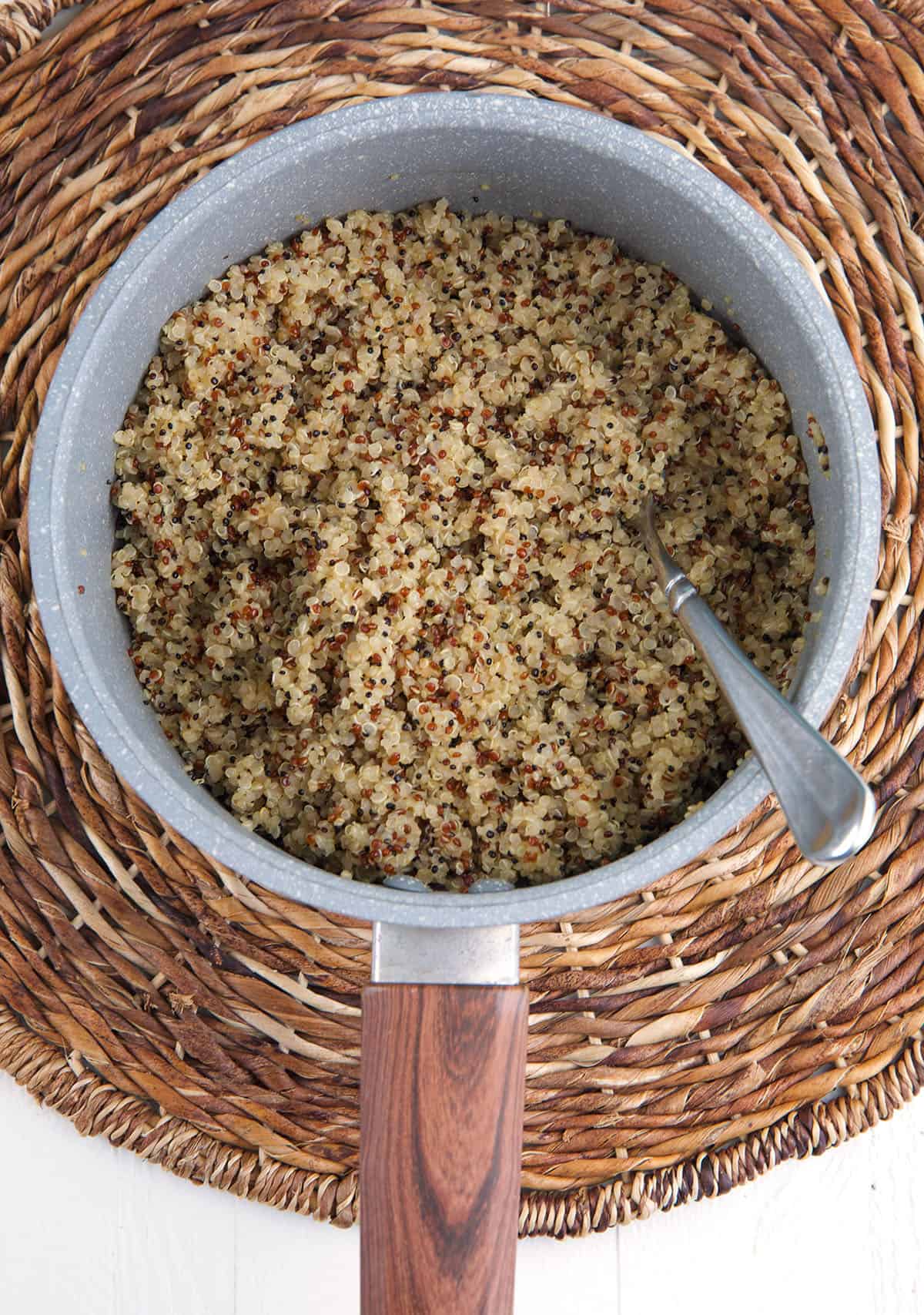 A pot is filled with cooked quinoa. 