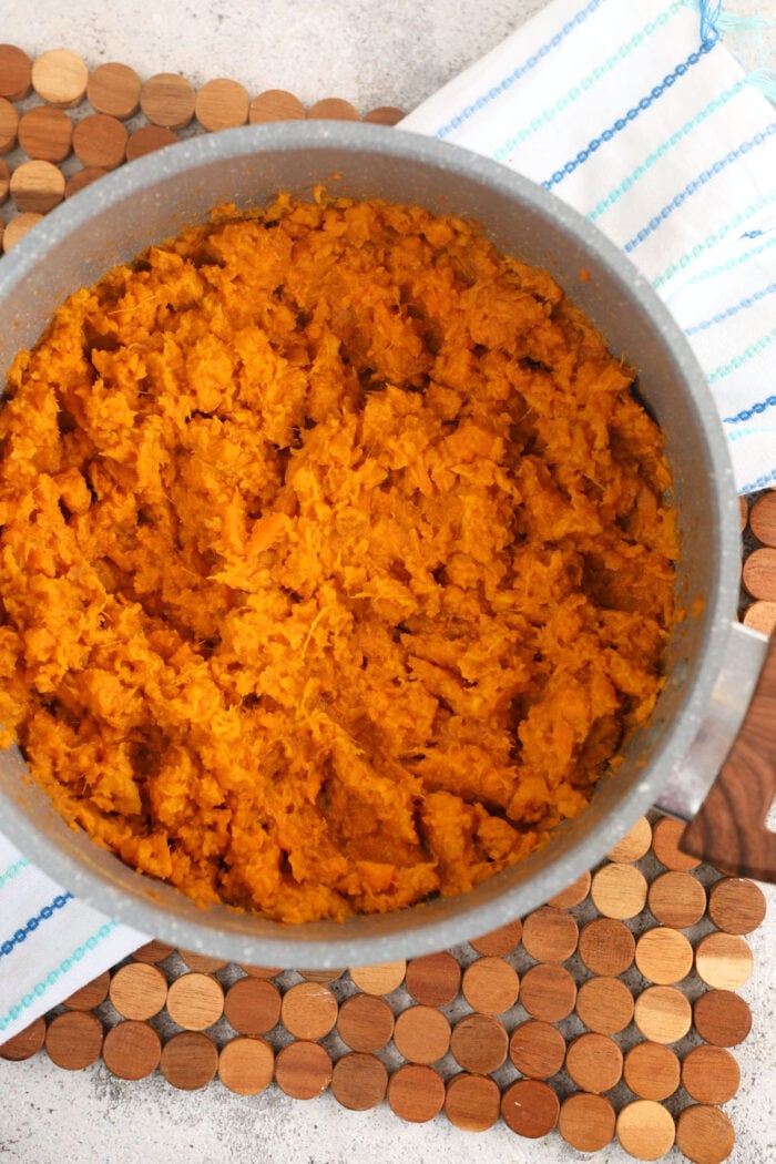 Creamy mashed sweet potatoes in mixing bowl