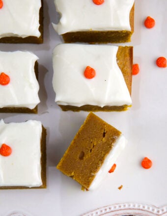 A single pumpkin bar has been flipped on its side to reveal a cooked through center.