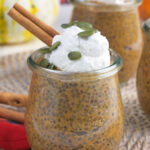A glass jar filled with chia pudding is topped with whipped cream.