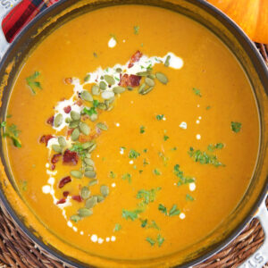 A large pot is filled with pumpkin soup.