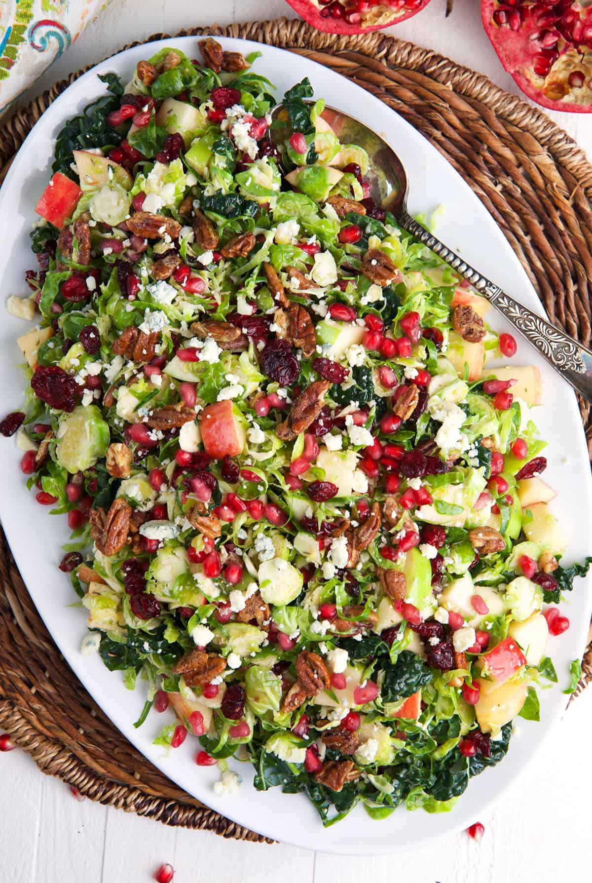 An oval shaped serving plate is topped with brussels sprout salad.