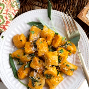 A white plate is topped with sweet potato gnocchi.