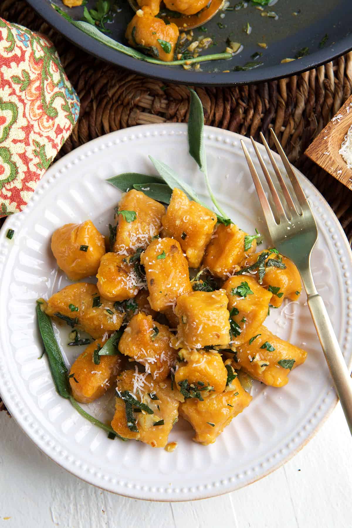 A white plate is topped with sweet potato gnocchi.