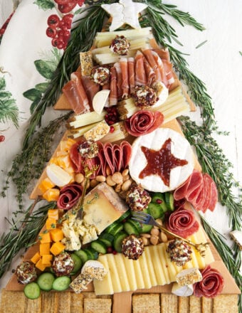 A Christmas charcuterie board is presented on a white surface.