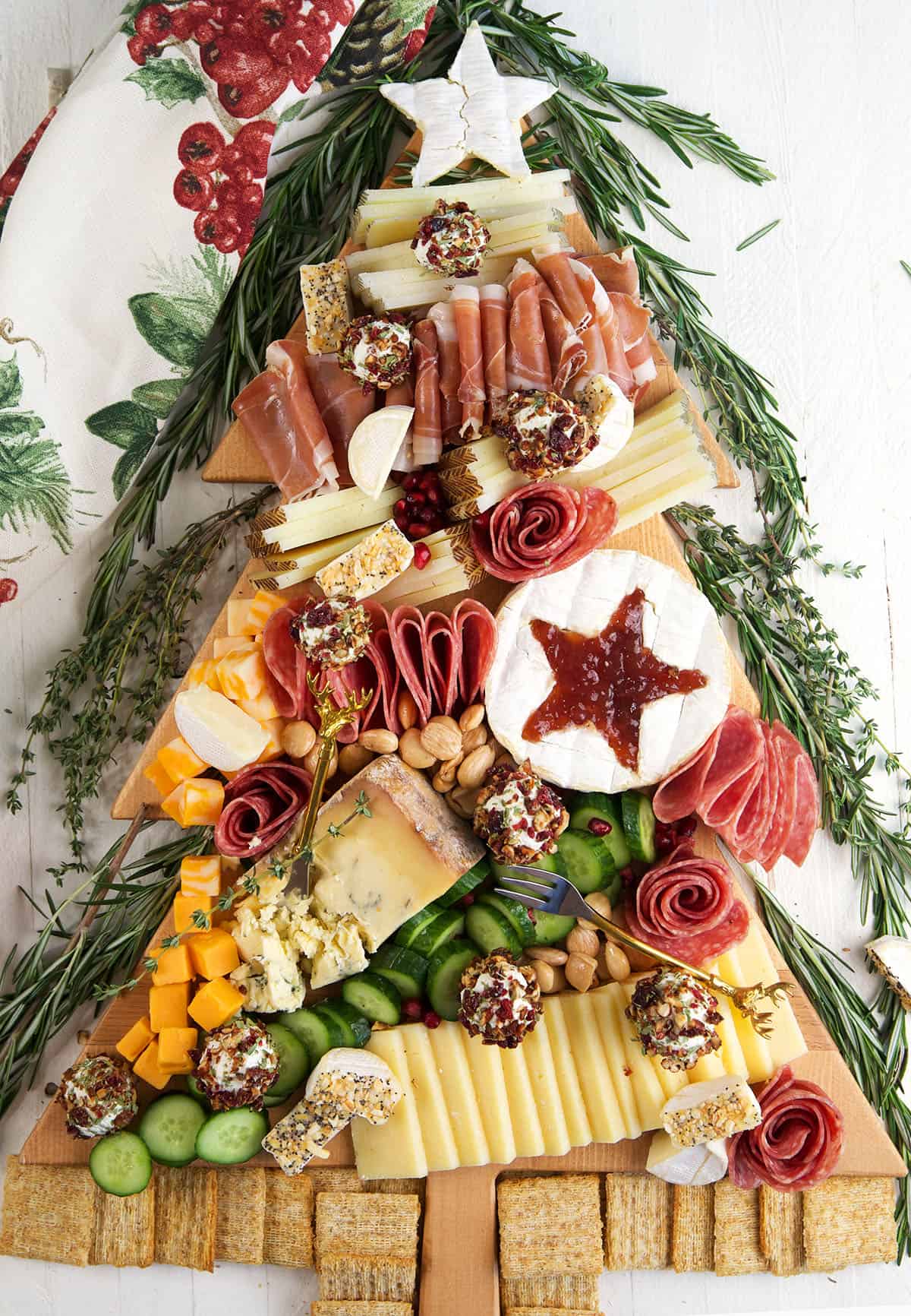 A Christmas charcuterie board is presented on a white surface. 