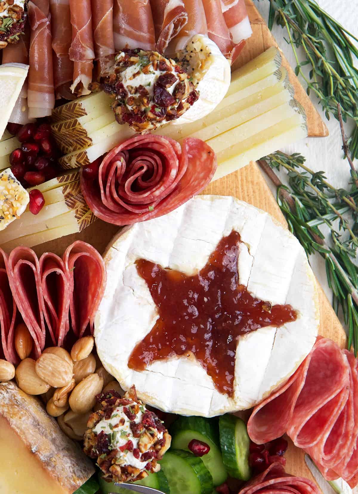 A wheel of brie has a star shape cut off the top.