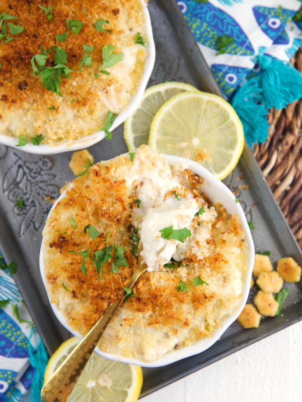 Lemon slices are placed next to two servings of crab imperial.