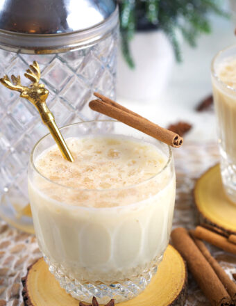 A reindeer stirrer is placed in a cup of eggnog white russian.