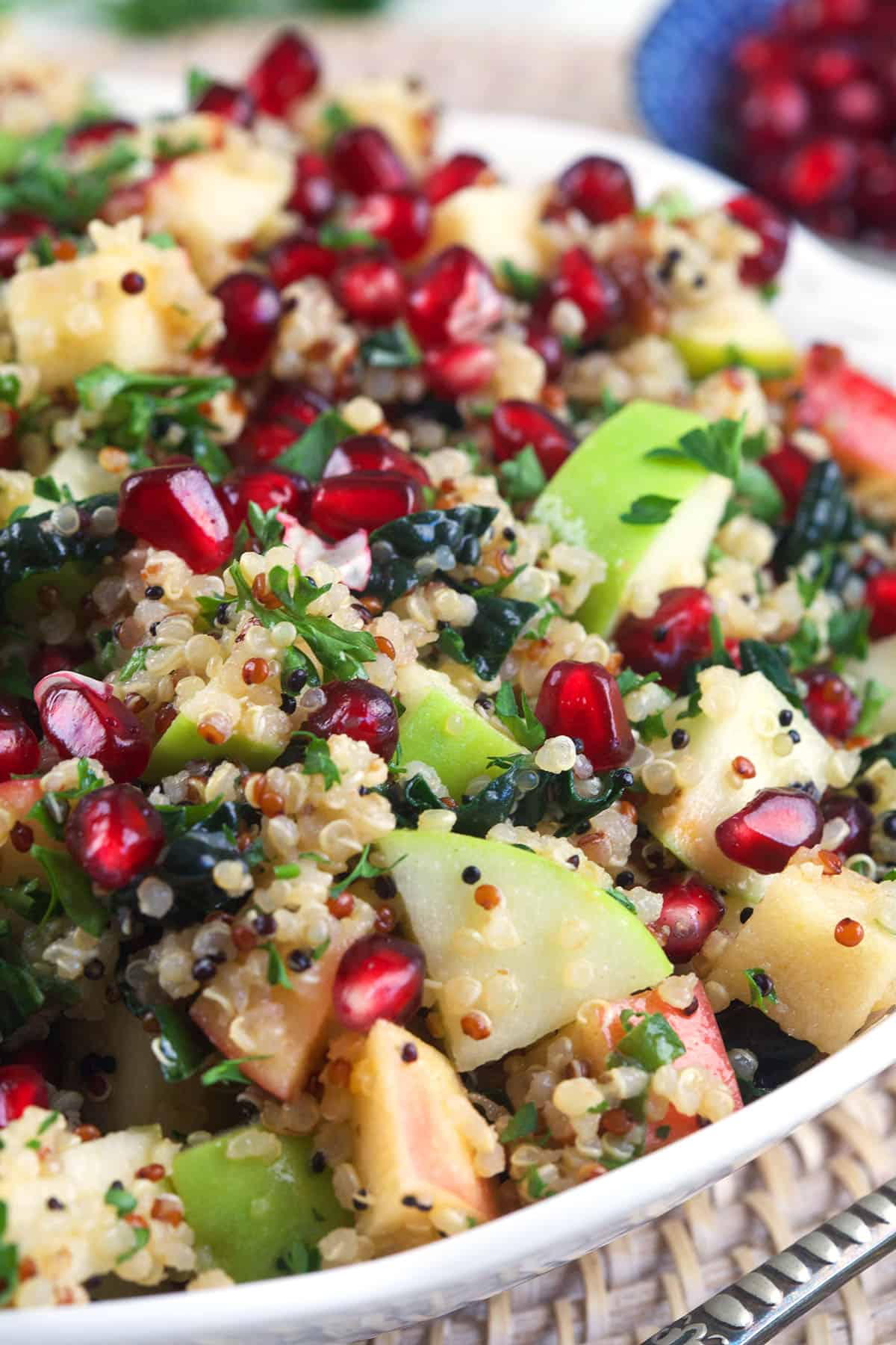 A large white bowl is filled with harvest quinoa salad. 