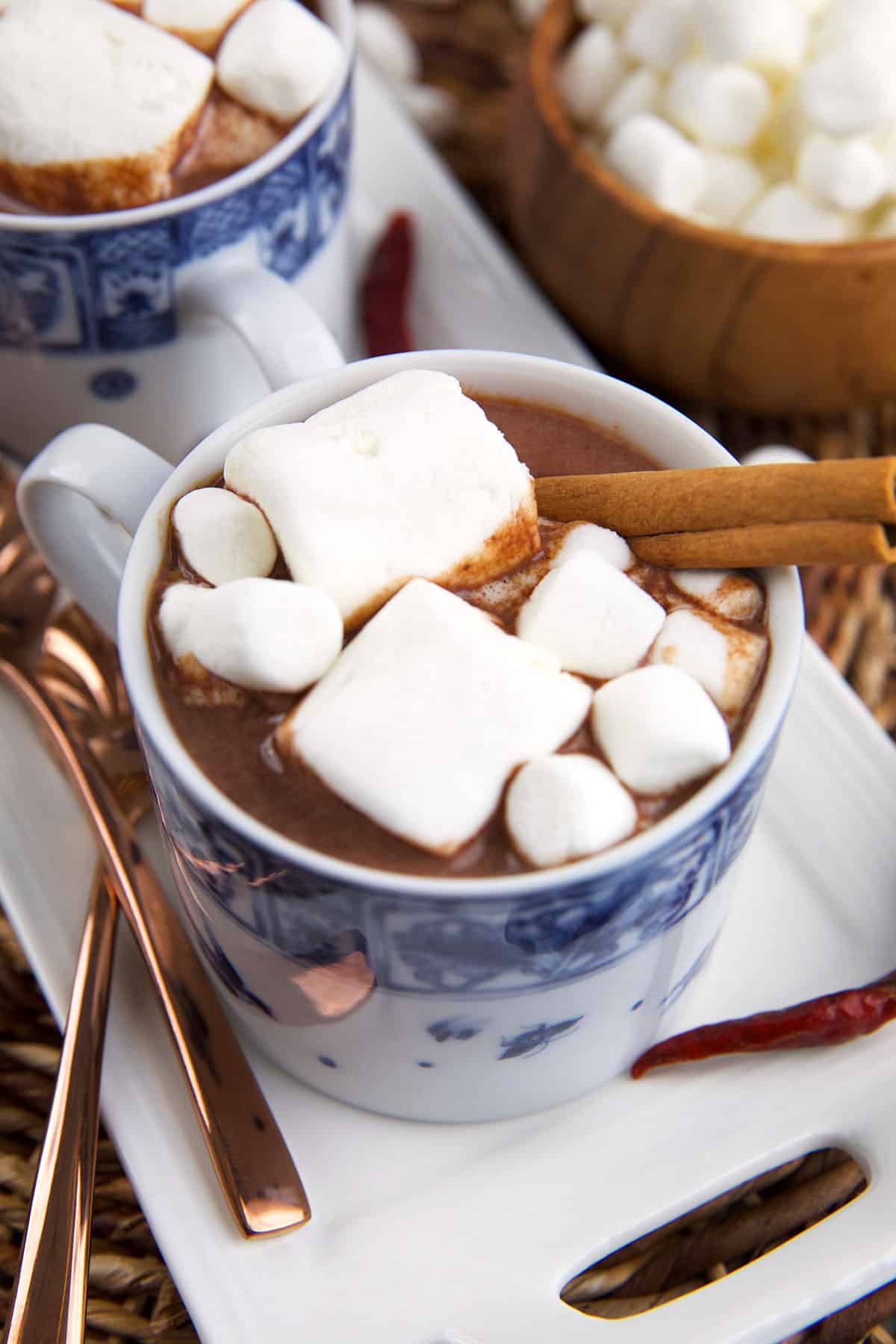 Marshmallows and a cinnamon stick garnish a cup of Mexican hot chocolate. 