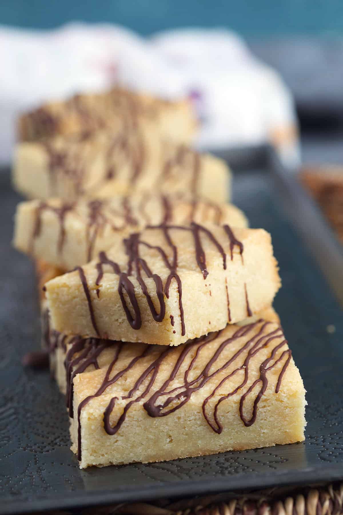 Shortbread cookies are stacked on a platter. 