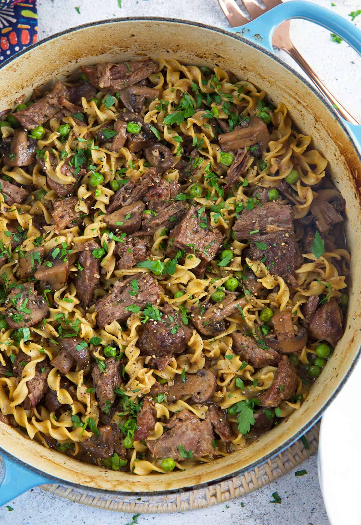 A large pot is filled with beef and noodles. 