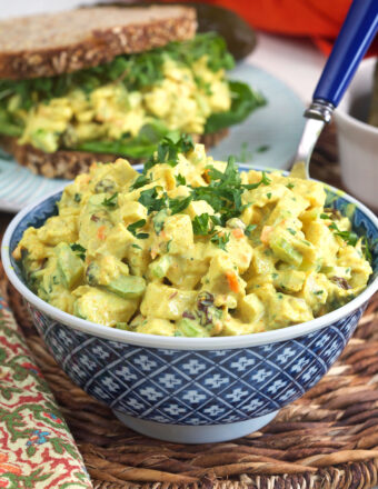 A bowl is filled with curried chicken salad.