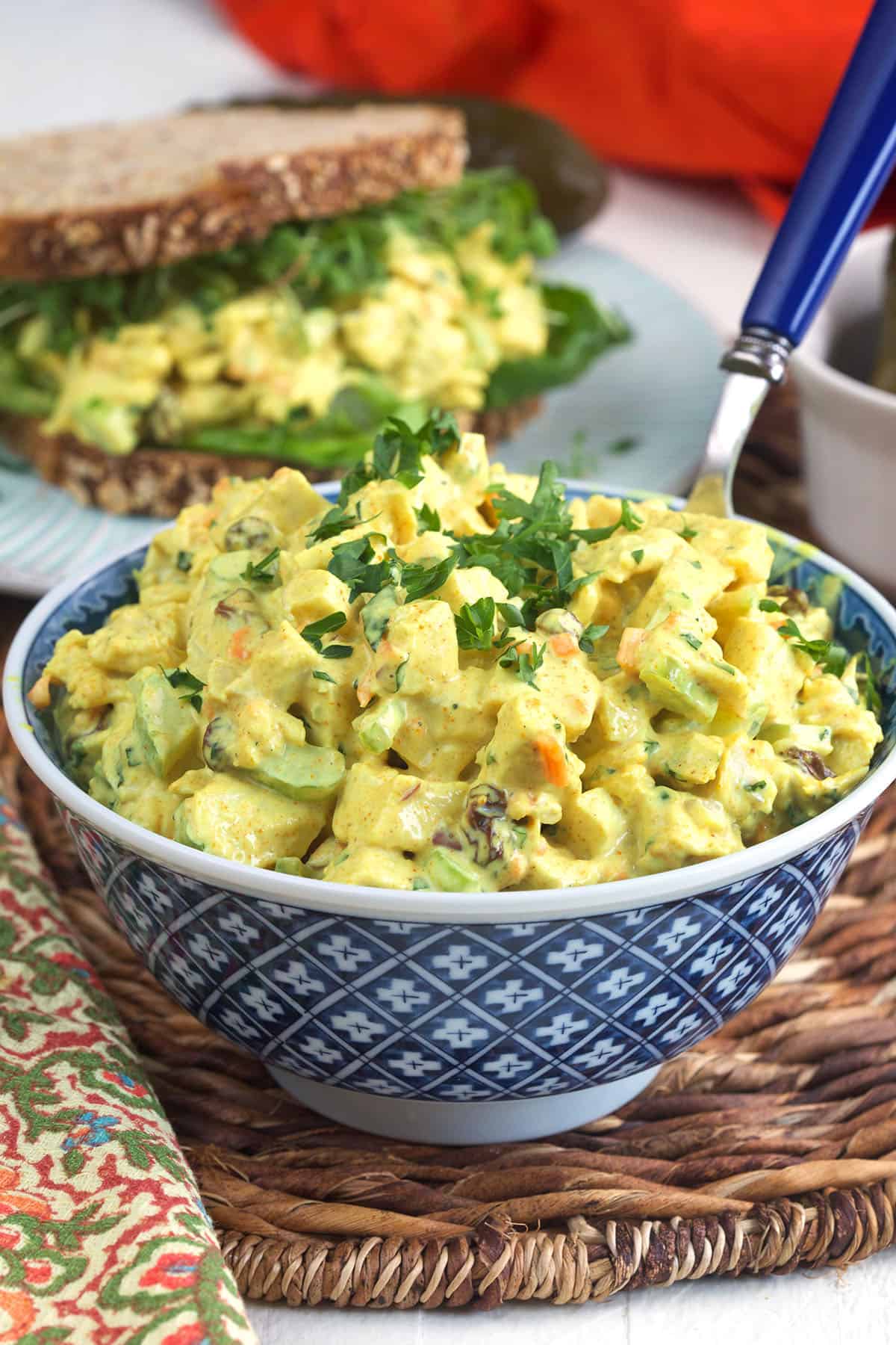 A bowl is filled with curried chicken salad. 