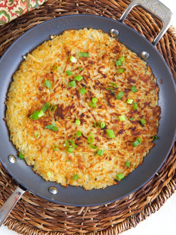 A skillet is filled with cooked hash browns.