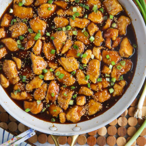 A skillet is filled with sesame chicken.
